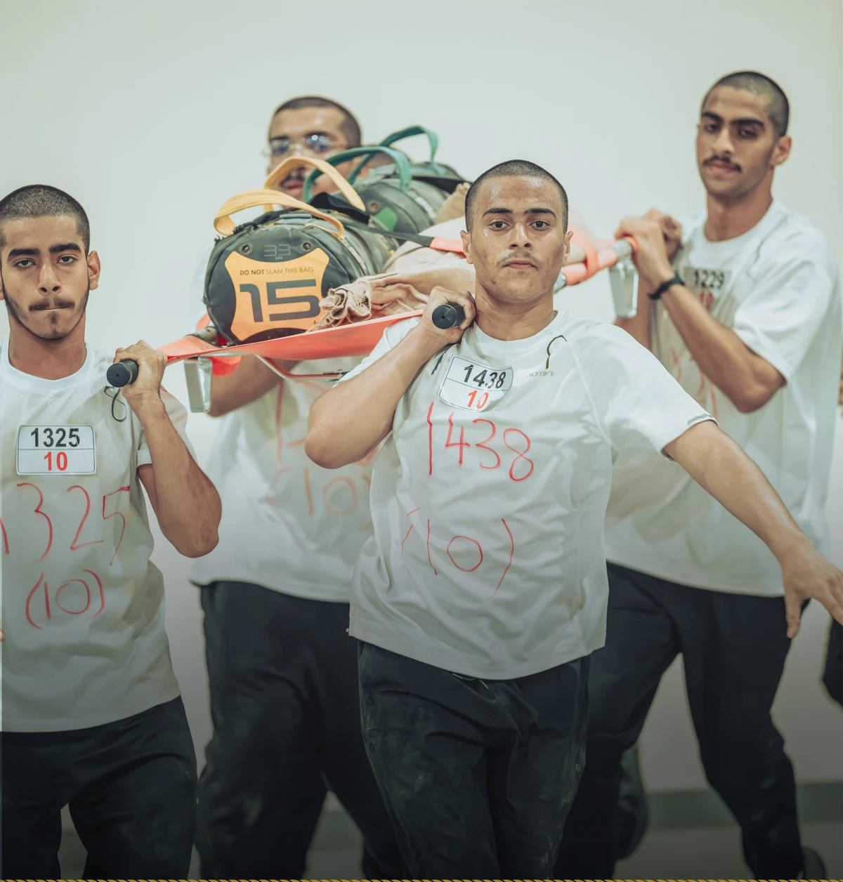 Beladi participants carrying a stretcher together during an exercise